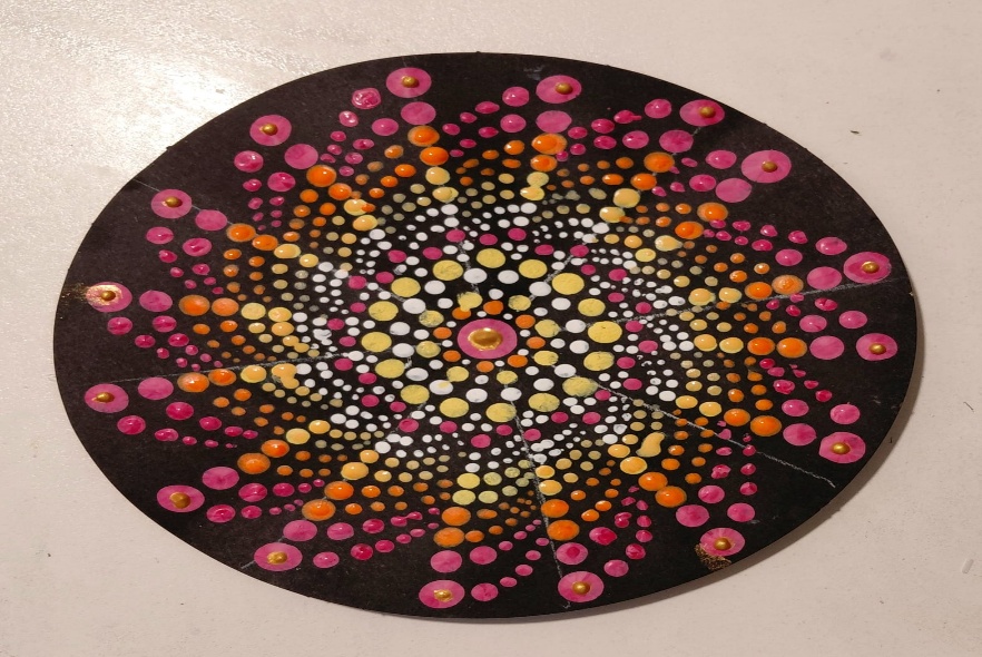 A circular painted surface with colorful dotsAI-generated content may be incorrect.