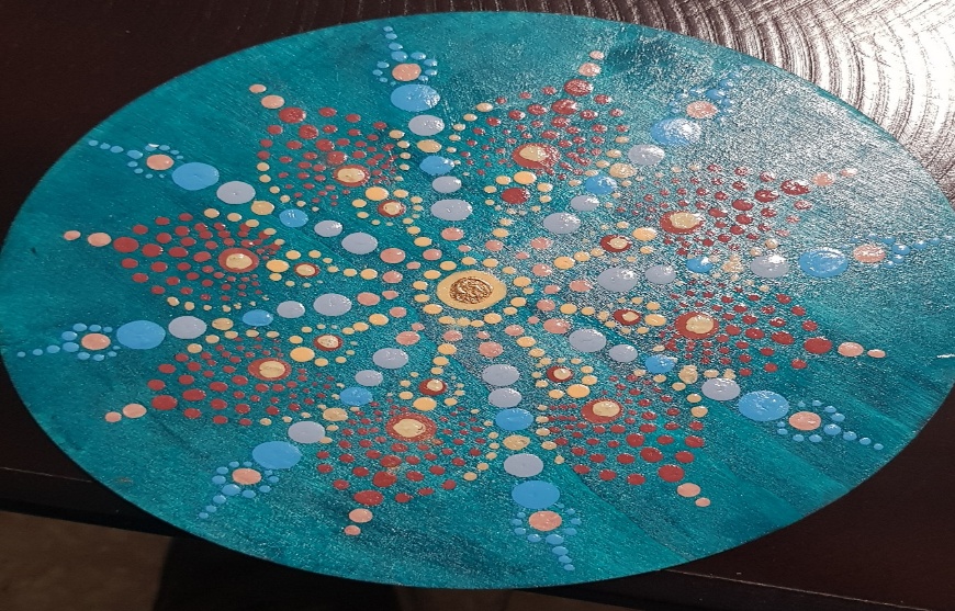 A painted blue circle with red and blue dots on itAI-generated content may be incorrect.